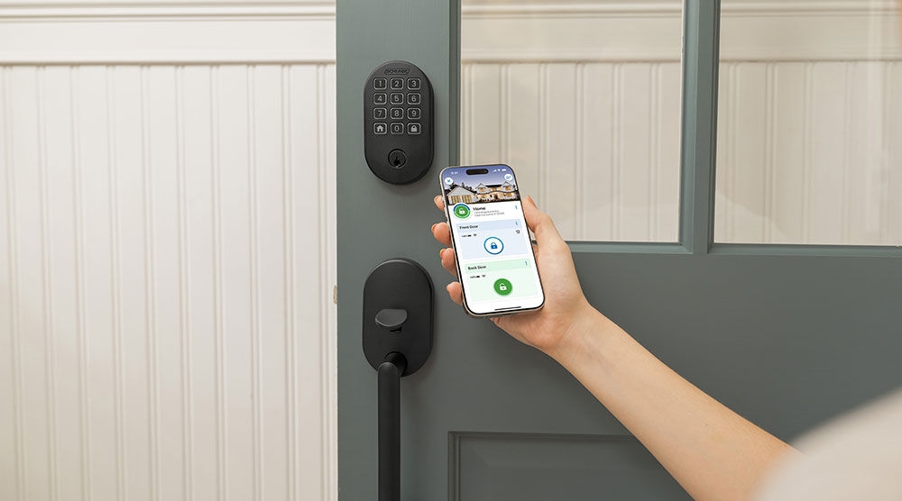 person programming their smart lock before going on vacation