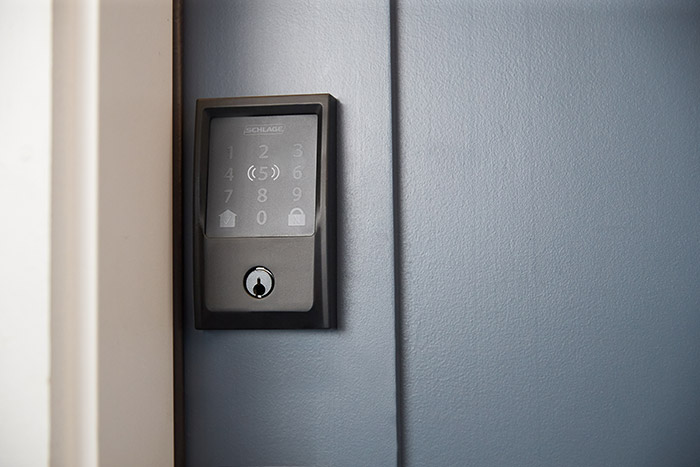 Schlage smart alex door lock installed on grey door