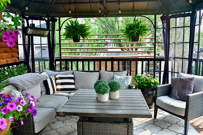 Sheltered outdoor summer lanai living space for relaxing on warm days in backyard oasis or tropical vacation rental setting
